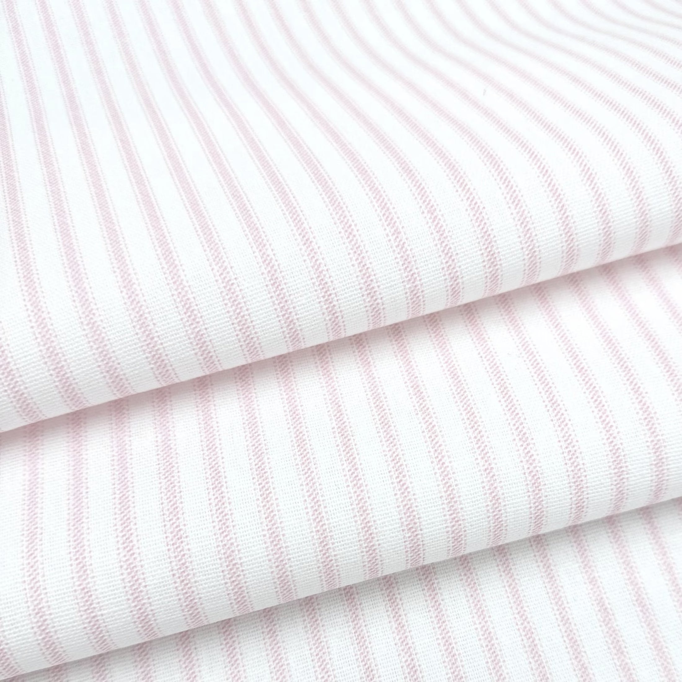 a close-up view of a fabric with horizontal pink stripes.