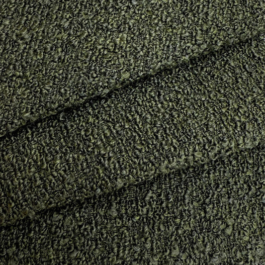 a close-up view of a textured fabric with a dark green or black color. The fabric appears to be made of a tightly woven material, giving it a distinctive and intricate appearance.
