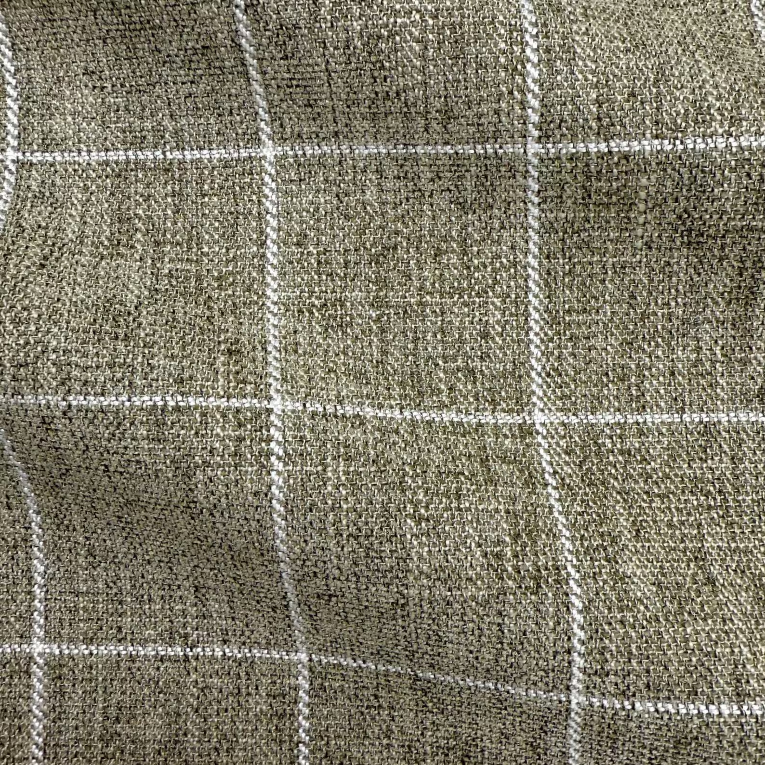 a close-up view of a textured fabric with a grid-like pattern of white lines.