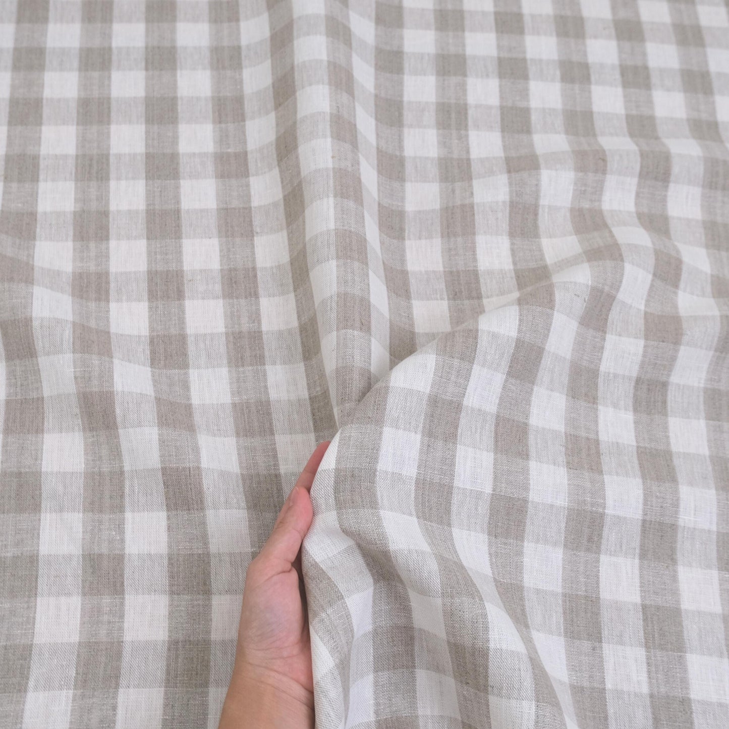 Taupe checkered linen fabric closeup with neutral gingham pattern