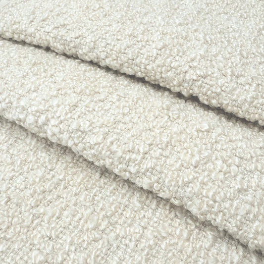 A close-up image of a soft, fluffy, and textured fabric, possibly a type of wool or a similar material.
