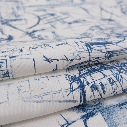 The image is a close-up view of a fabric with a blue and white abstract pattern, featuring various lines and shapes that create a textured and visually interesting design.