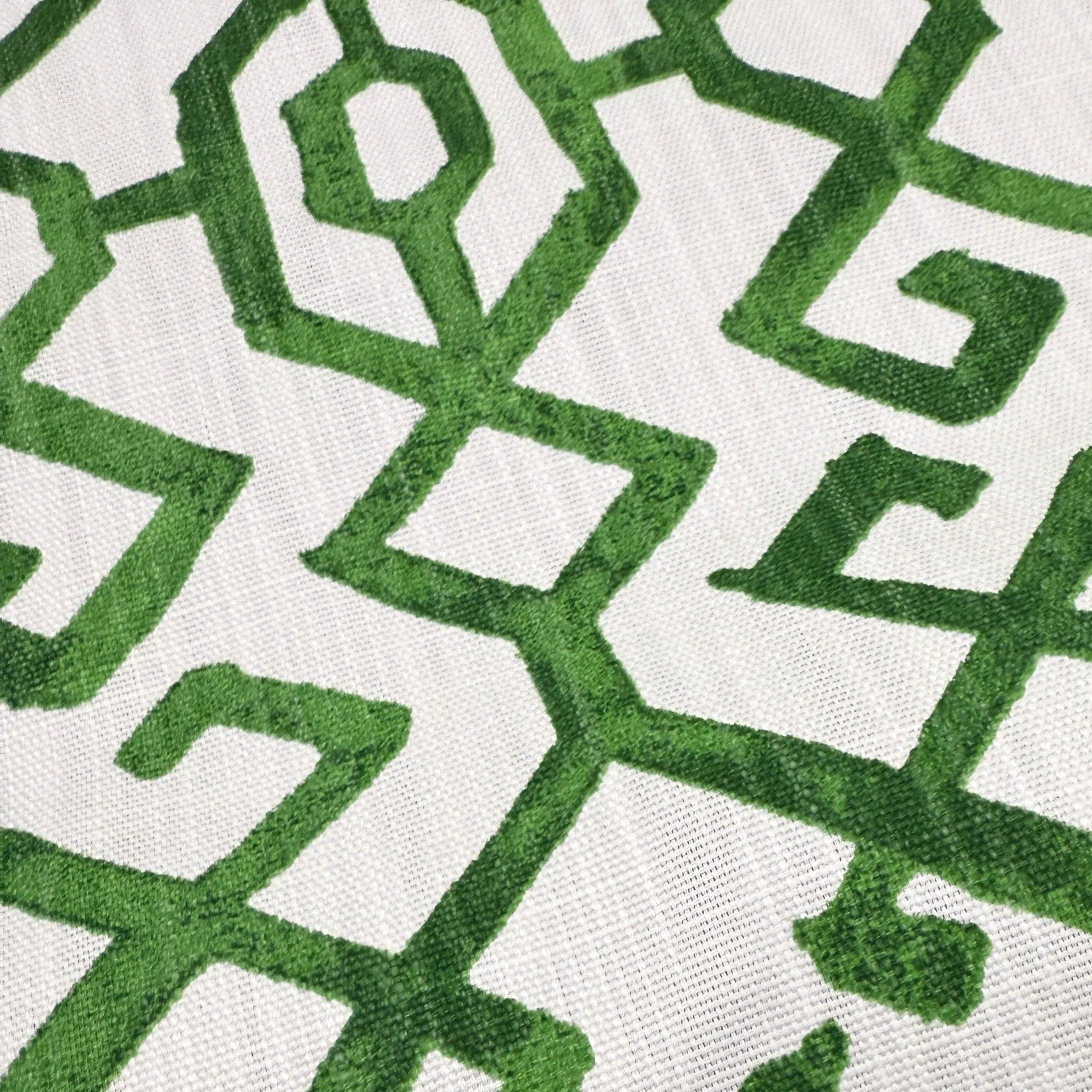 a close-up view of a fabric with a repeating pattern of green geometric shapes, creating a visually striking and intricate design.