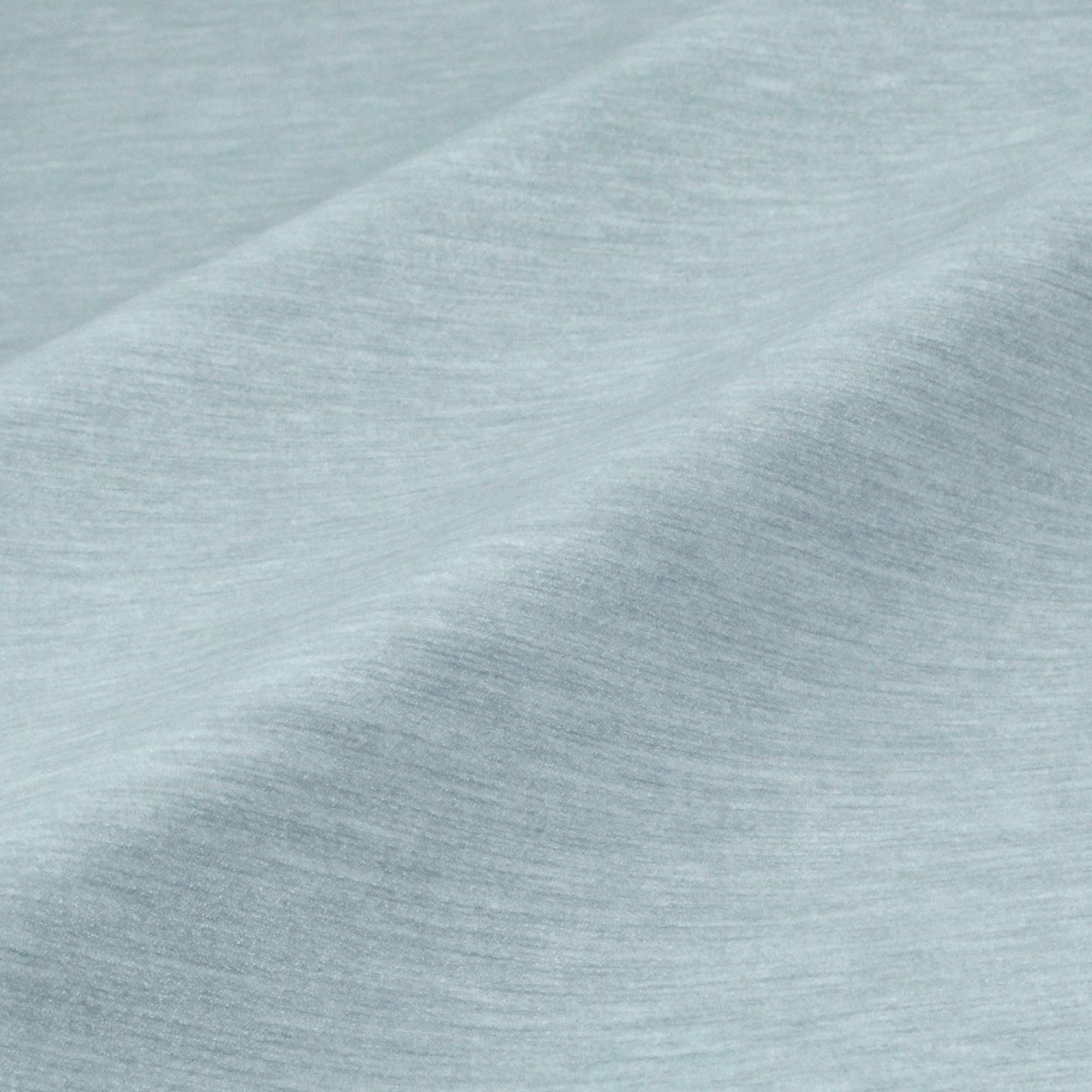 a close-up view of a textured fabric, possibly a piece of clothing or a textile. The fabric appears to be a light blue color, with a slightly wrinkled and folded appearance. The image does not contain any discernible objects or actions, and there are no specific actions or objects that can be described in detail.
