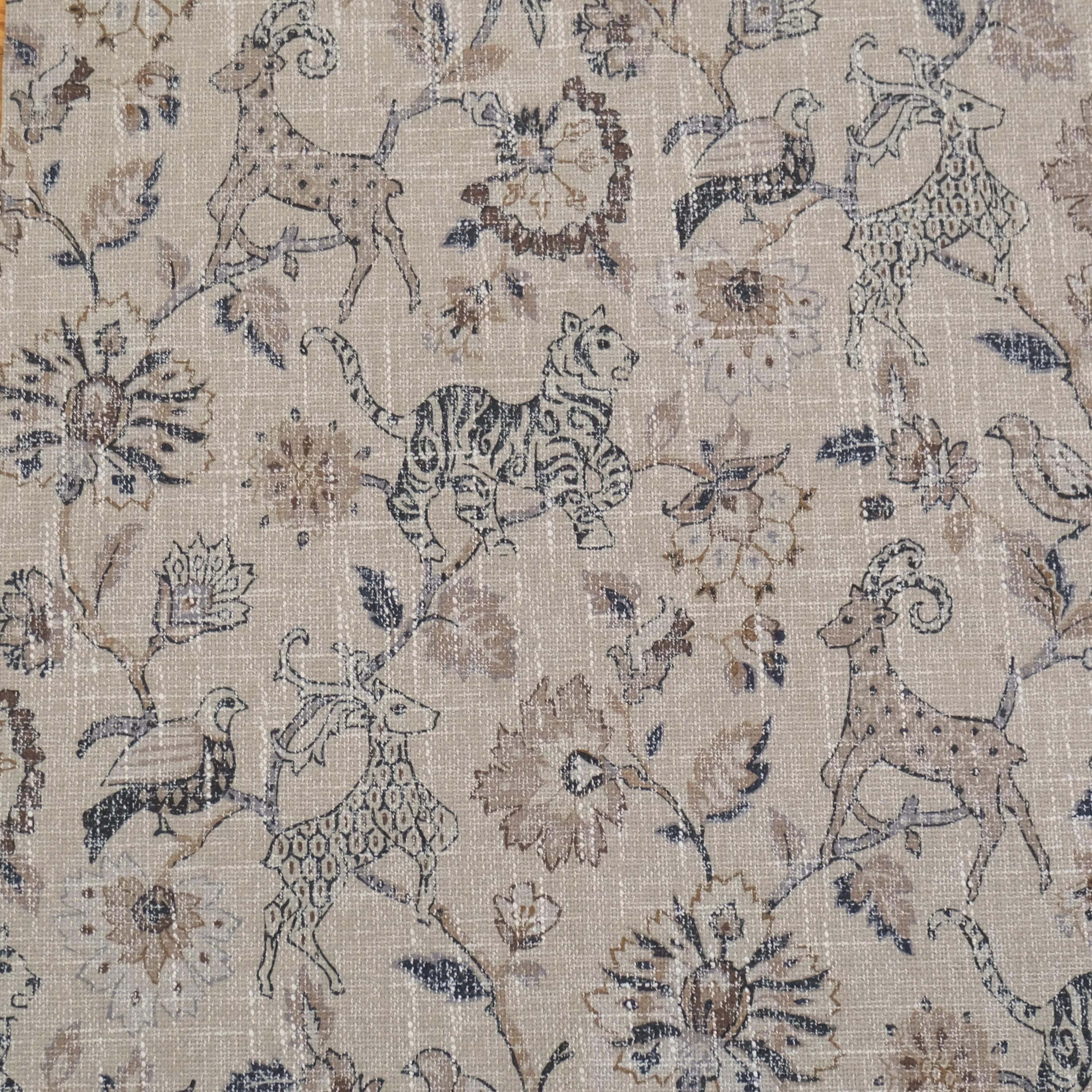Beige fabric with a repeating pattern of stylized animals and floral elements. The design features a deer, tiger, and birds among ornate flowers and foliage. The color palette includes shades of brown, beige, and hints of green, creating a vintage, textured look.