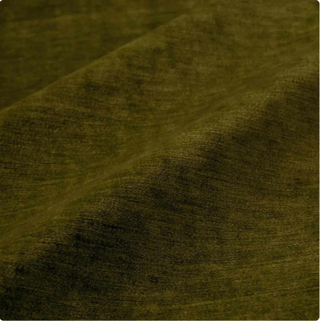 a close-up view of a textured fabric, possibly a piece of clothing or a textile. The fabric appears to be a dark green or olive-colored material, with a slightly wrinkled and folded appearance.