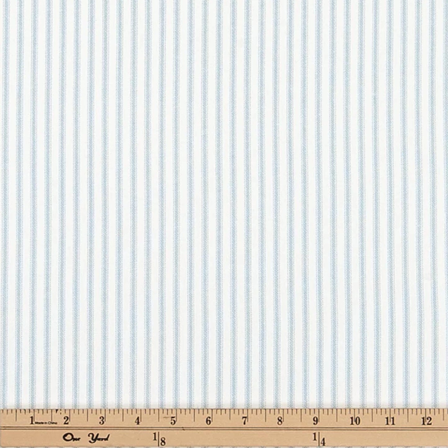 a ruler with a blue and white striped fabric