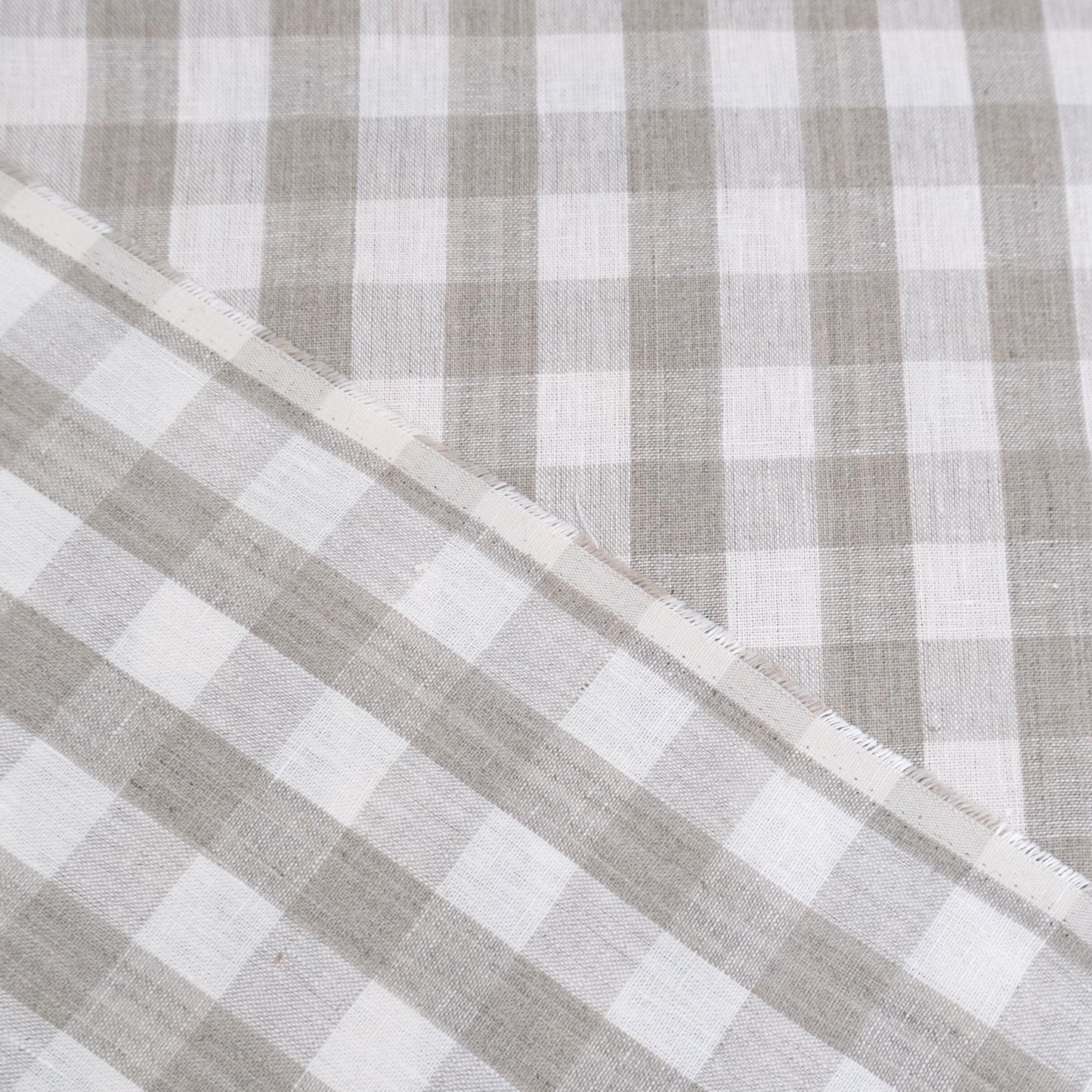 Taupe gingham linen fabric rolled in drapery weight