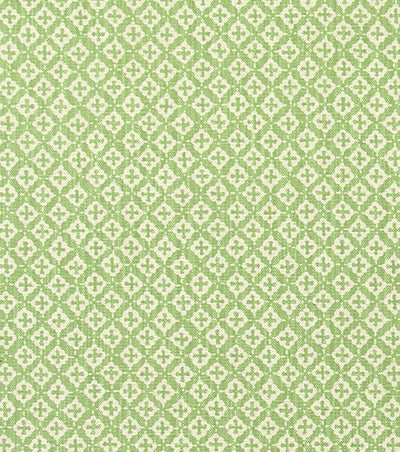 Fenwick Green quatrefoil trellis fabric by the yard in leaf green on cream, swatch with ruler