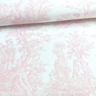 a close-up view of a pink and white fabric with a repeating pattern of a woman and a child, along with other figures and trees.