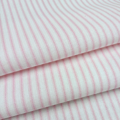 a close-up view of a fabric with pink and white striped patterns.