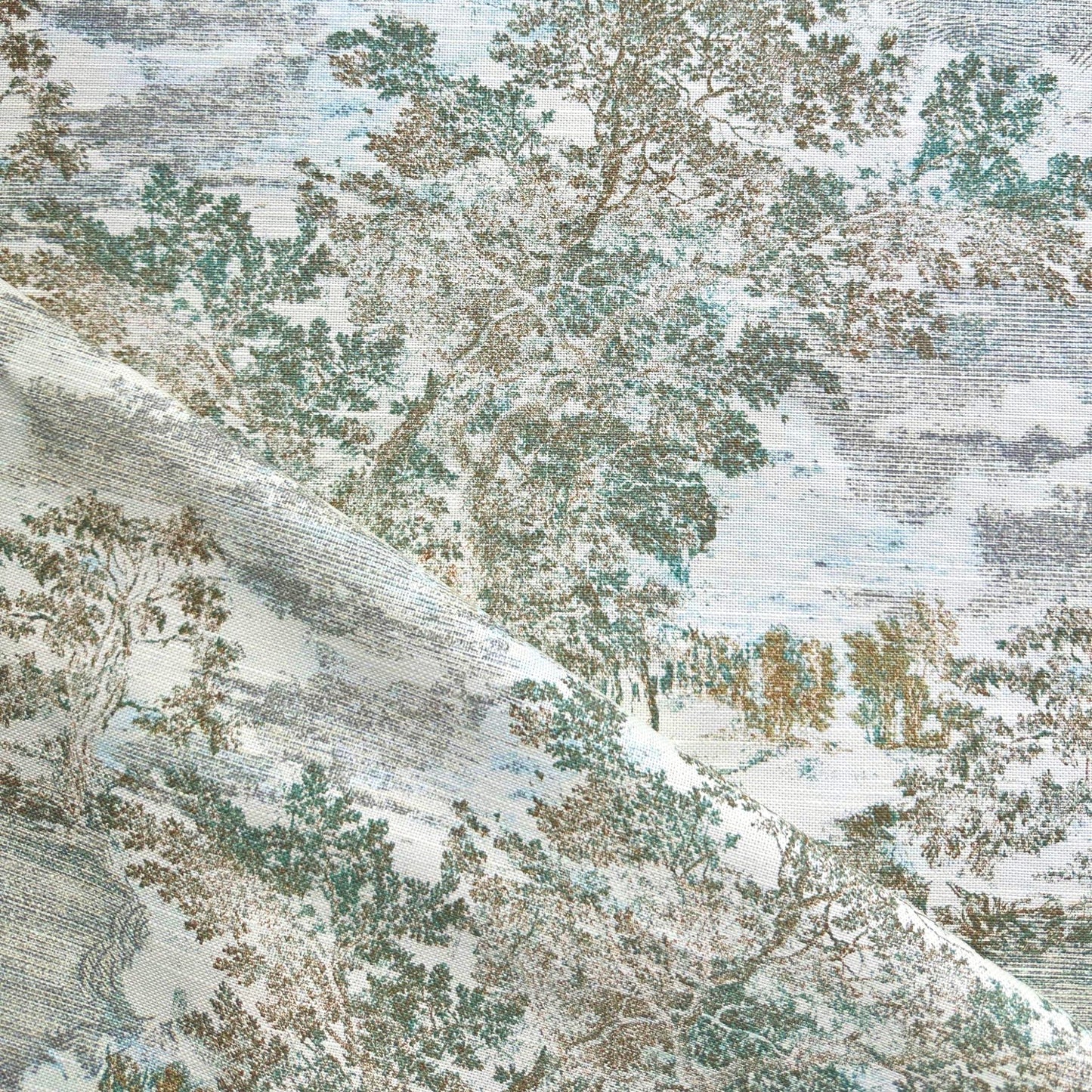 The image is a close-up of a fabric with a pattern of trees and foliage in various shades of green, blue, and brown. The fabric appears to be a type of wallpaper or textile with a textured, natural-looking design.