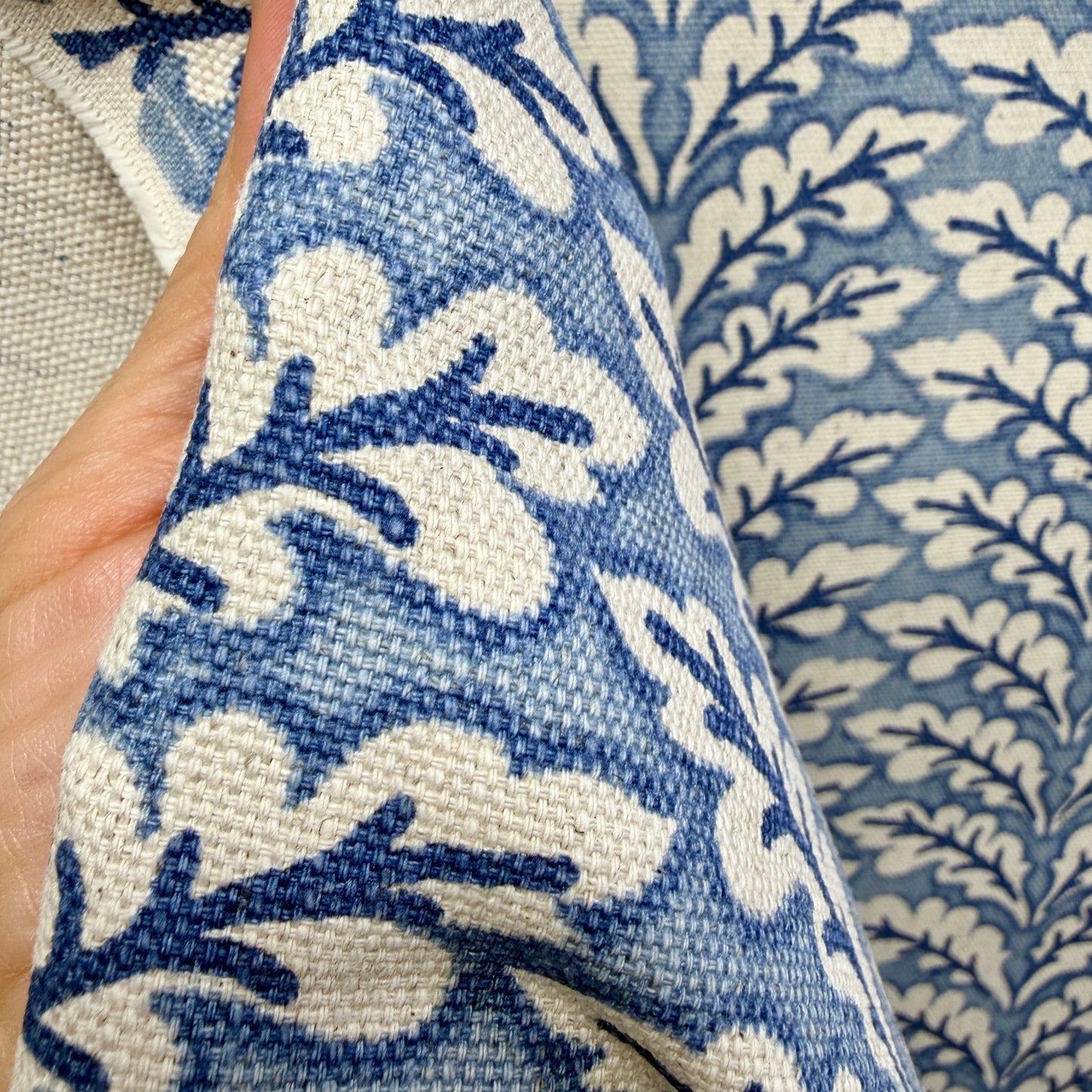 Close-up of blue and cream vine pattern fabric highlighting texture and weave detail