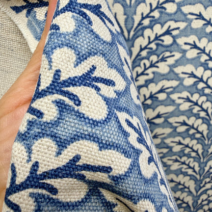 Close-up of blue and cream vine pattern fabric highlighting texture and weave detail