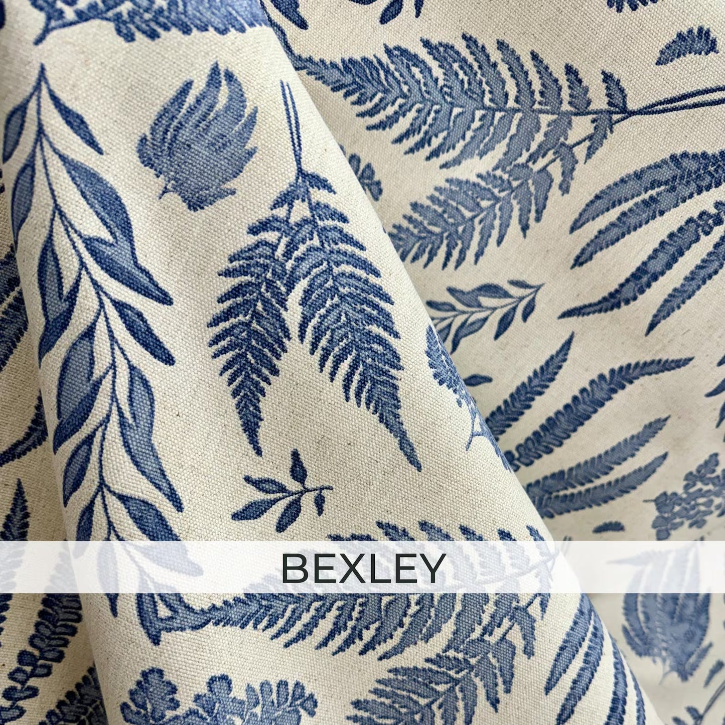 Blue fern botanical cotton linen fabric with detailed foliage print in soft blue on natural background