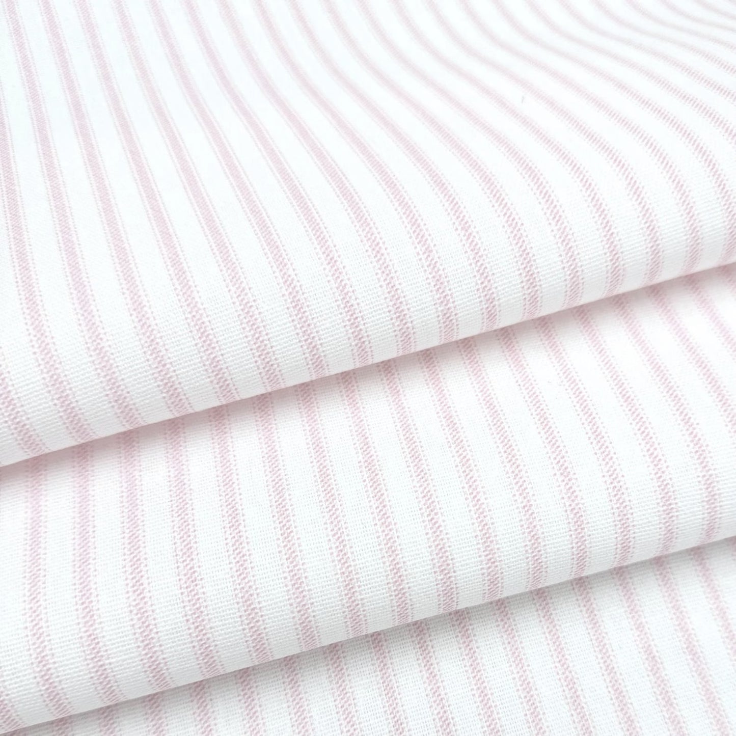 a close-up view of a fabric with horizontal pink stripes.