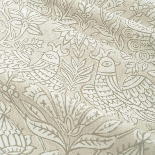 a close-up view of a fabric with a repeating pattern of birds and leaves in shades of beige and gray.