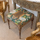 a decorative chair with a vibrant tiger print cushion, placed on a carpeted floor.