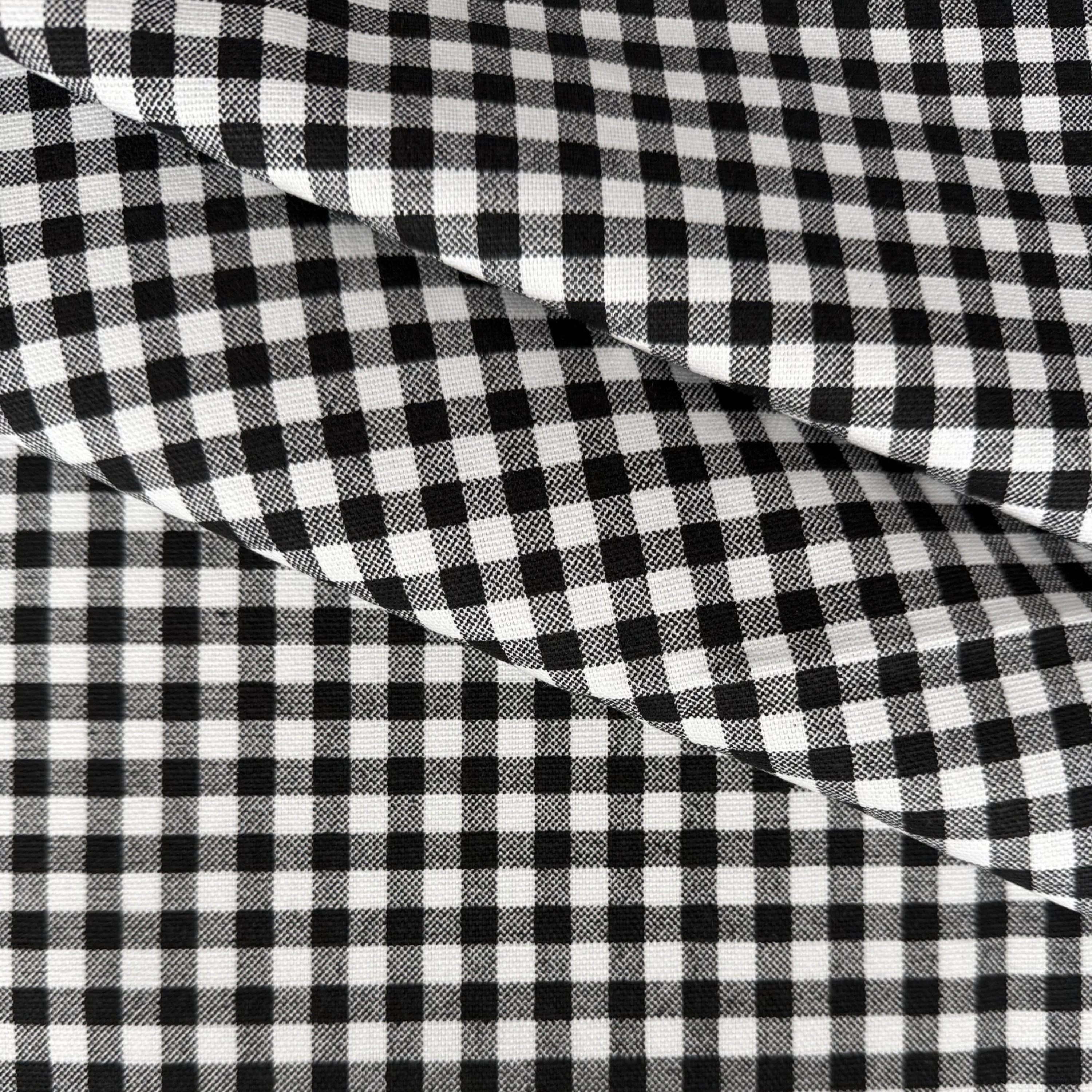 a close-up view of a fabric with a distinctive black and white checkered pattern.