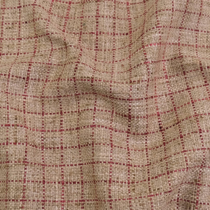 a close-up view of a fabric with a checkered pattern in shades of beige and red.