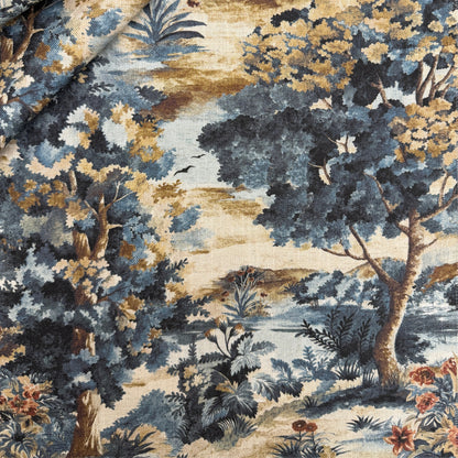 The image is a detailed fabric print featuring a lush, colorful landscape with trees, flowers, and foliage in shades of blue, green, and gold.