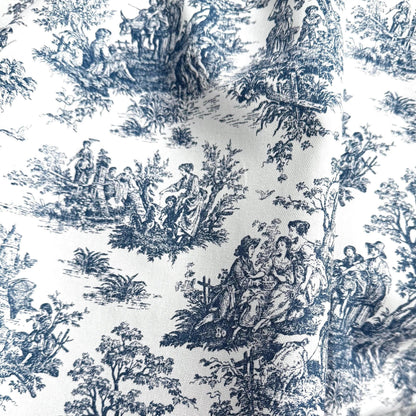 The image is a close-up of a fabric with a repeating pattern of black and white illustrations depicting people in various activities, such as sitting, standing, and interacting with nature.