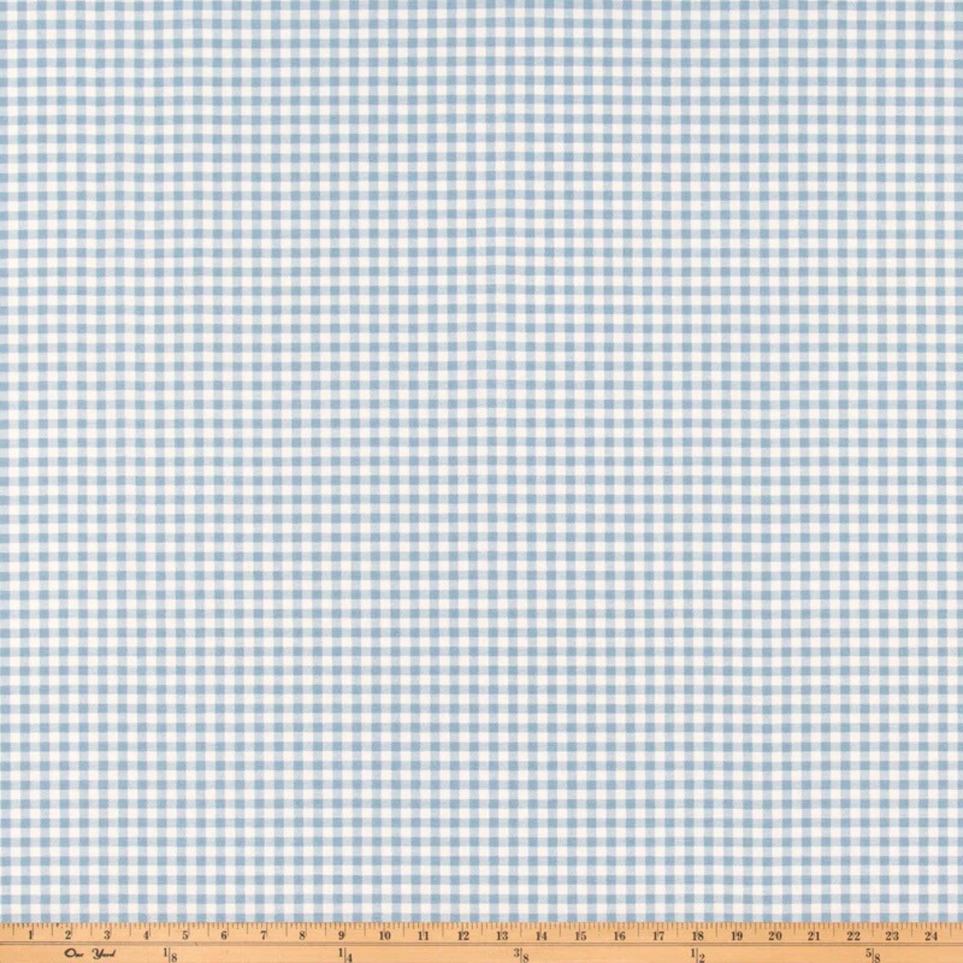 a blue and white checkered fabric with a ruler