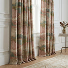 Floor-to-ceiling luxury drapery panels in Pink Scenic Forest Fabric styled in a bright living room.