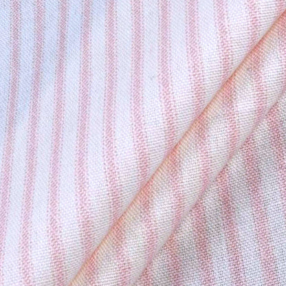 a close-up view of a fabric with horizontal pink and white stripes. The fabric appears to be folded or rolled, creating a visually interesting pattern.