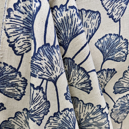 Blue and cream ginkgo leaf fabric draped to show large scale botanical pattern and texture