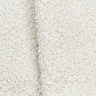A close-up image of a white, fluffy fabric with a textured appearance.
