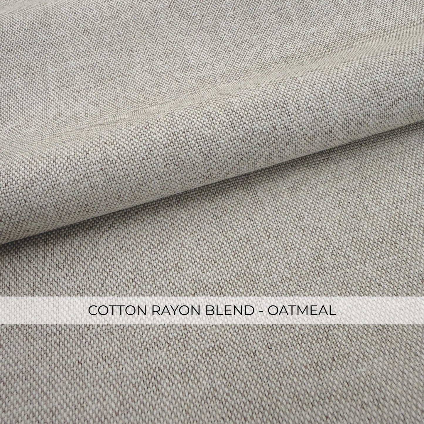 a close-up view of a fabric with a textured, woven appearance. The fabric appears to be a blend of cotton and oatmeal, as indicated by the text "COTTON RAYON BLEND - OATMEAL" in the image.