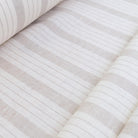 Roll of taupe stripe linen fabric neatly displayed to show stripe repetition, texture, and soft neutral taupe tones. Great for rustic farmhouse curtains, neutral cottage décor, and DIY sewing projects like placemats, runners, and table linens. This fabric combines the durability of linen with a light airy hand, making it perfect for sewing lightweight home décor pieces with a timeless stripe design.
