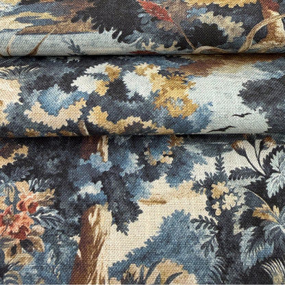The image is a close-up of a fabric with a floral pattern, featuring a mix of blue, green, and brown colors.