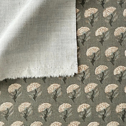 a close-up view of a fabric with a floral pattern, featuring a mix of white and gray colors. The fabric appears to be made of a soft, textured material, possibly cotton or linen. The pattern consists of repeating floral motifs, creating a visually appealing and intricate design.
