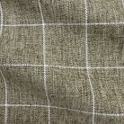 a close-up view of a textured fabric with a grid-like pattern of white lines.
