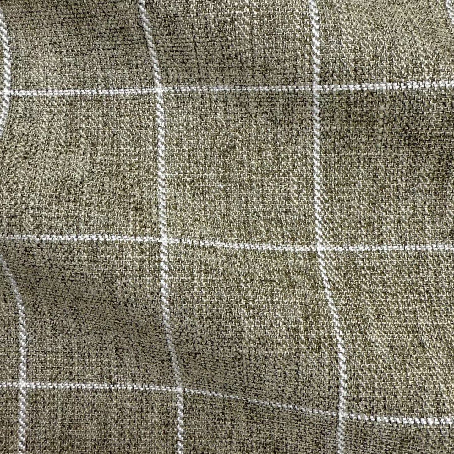a close-up view of a textured fabric with a grid-like pattern of white lines.