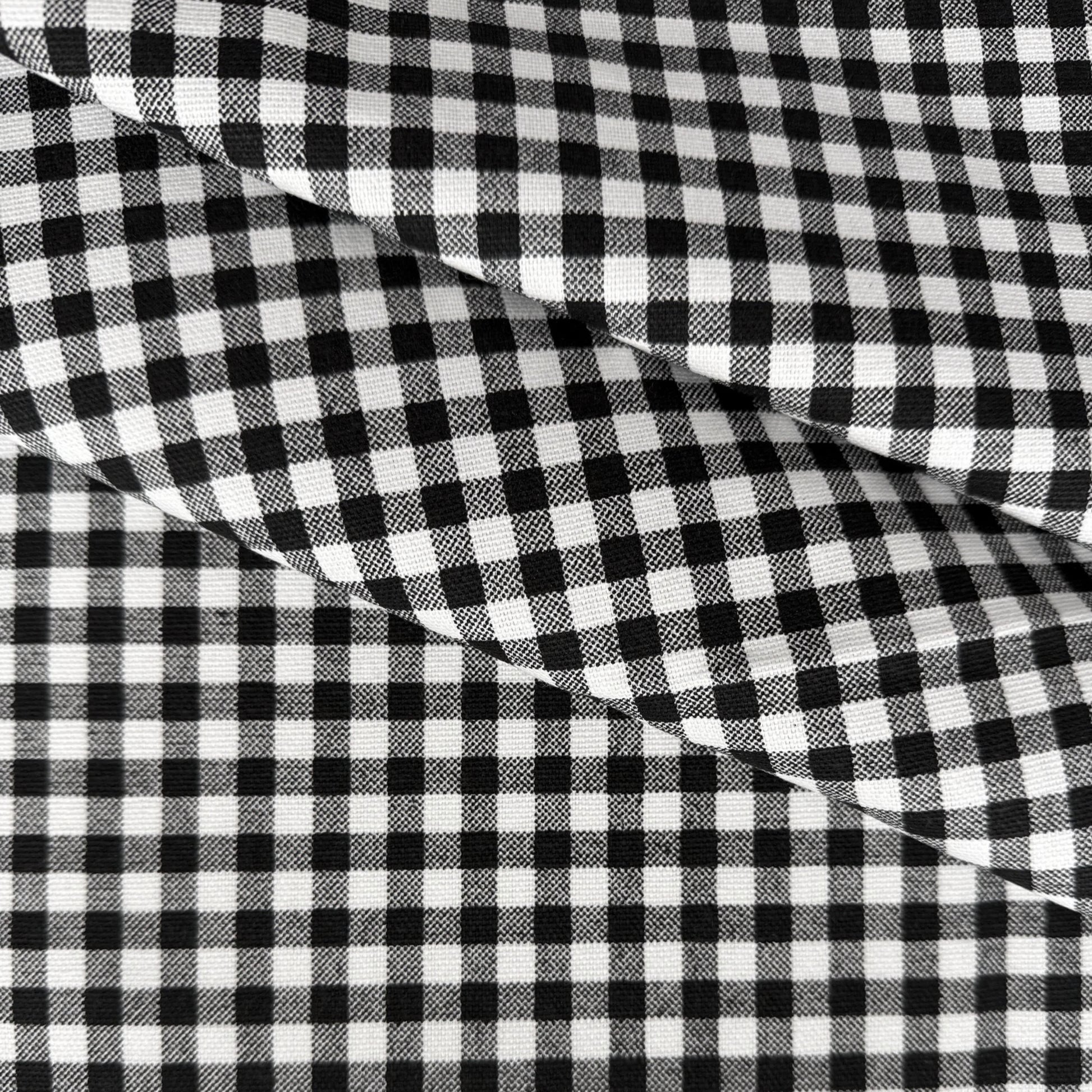 a close-up view of a fabric with a distinctive black and white checkered pattern.