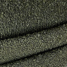 a close-up view of a textured fabric, possibly a piece of clothing or a textile. The fabric appears to be made of a material with a fuzzy, knitted or crocheted texture, giving it a somewhat rough and uneven appearance. The image does not contain any discernible objects or actions, and there are no specific actions or movements depicted. The focus is on the fabric's texture and pattern.
