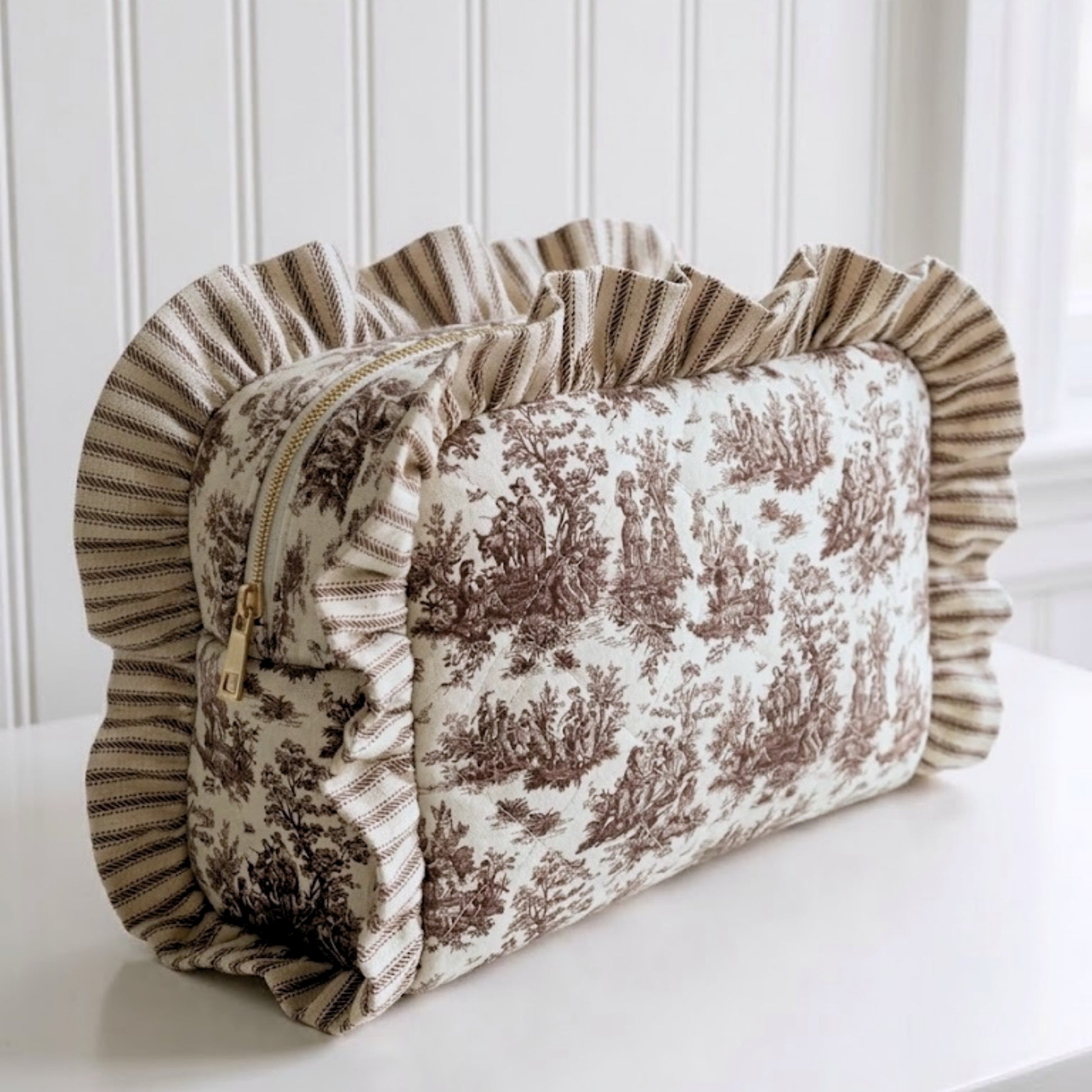 Handmade ruffled cosmetic bag crafted from coordinated brown toile and ticking stripe fabrics.