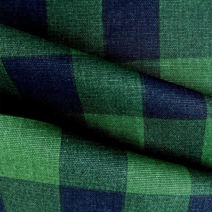 a close-up view of a fabric with a green and blue checkered pattern. The fabric appears to be made of a woven material, with a textured and wrinkled appearance.