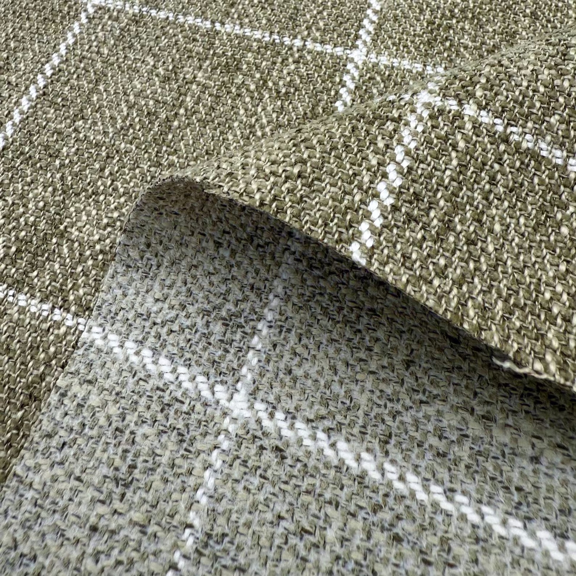 a close-up view of a woven fabric with a checkered pattern, featuring a mix of green and gray colors.