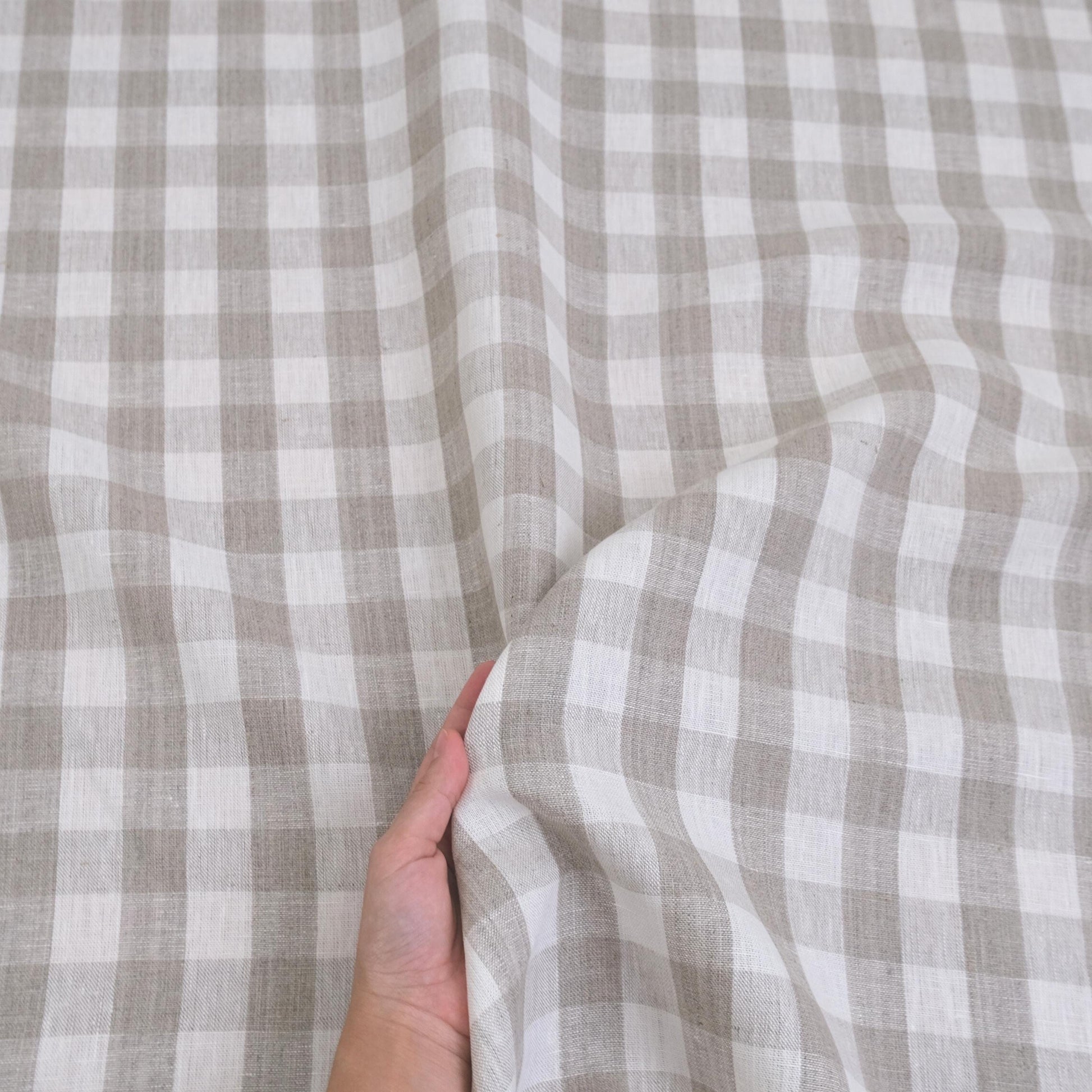 Taupe checkered linen fabric closeup with neutral gingham pattern