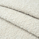 A close-up image of a soft, fluffy, and textured fabric, possibly a type of wool or a similar material.