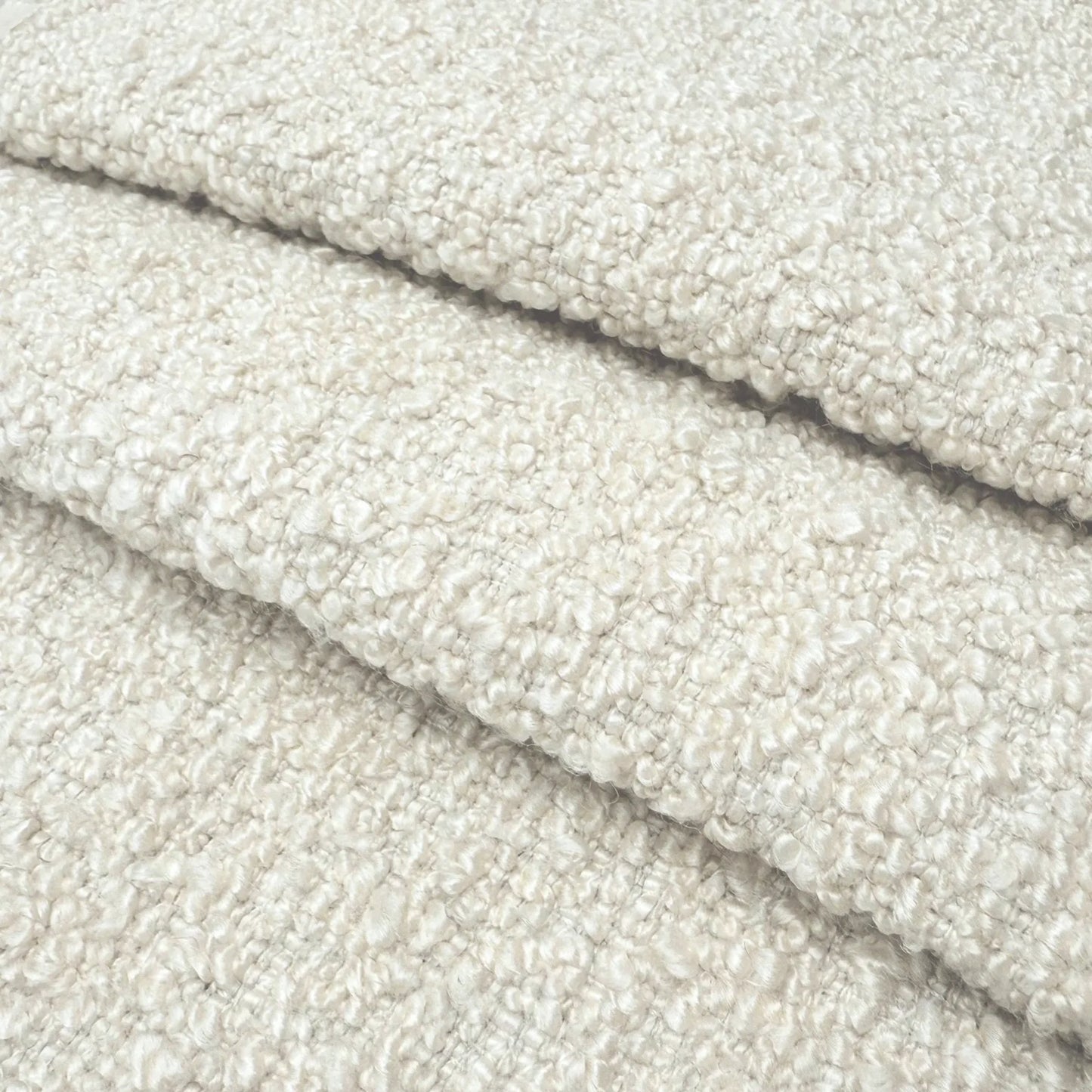A close-up image of a soft, fluffy, and textured fabric, possibly a type of wool or a similar material.