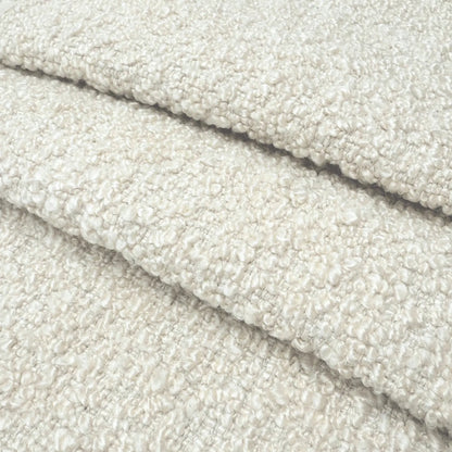 A close-up image of a soft, fluffy, and textured fabric, possibly a type of wool or a similar material.