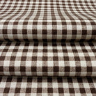 a close-up view of a fabric with a checkered pattern in shades of brown and white.