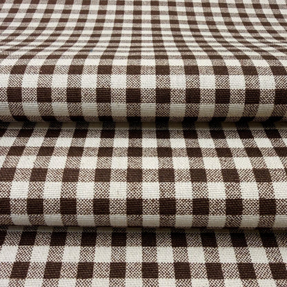 a close-up view of a fabric with a checkered pattern in shades of brown and white.