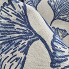 Close-up of blue botanical fabric with ginkgo leaf design showing detail and weave