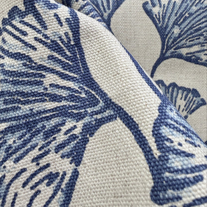 Close-up of blue botanical fabric with ginkgo leaf design showing detail and weave